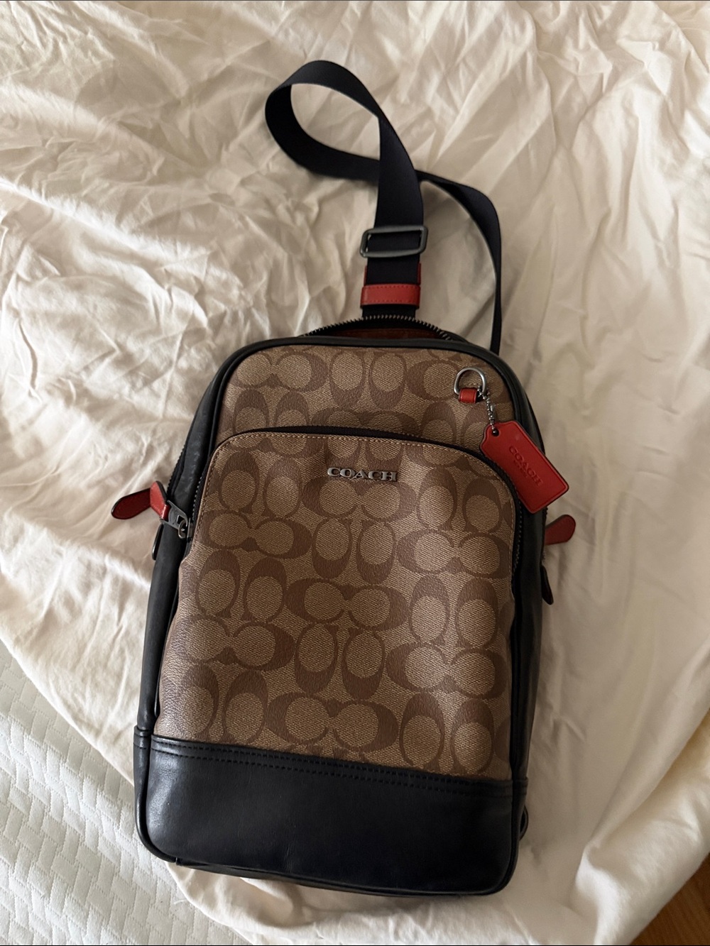 Coach Brown Signature Canvas Sling Bag with Black Trim and Red Accents